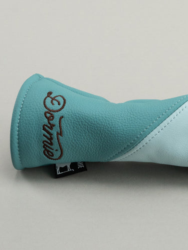 Light blue golf club head cover with a floral design and 'Dormie' branding