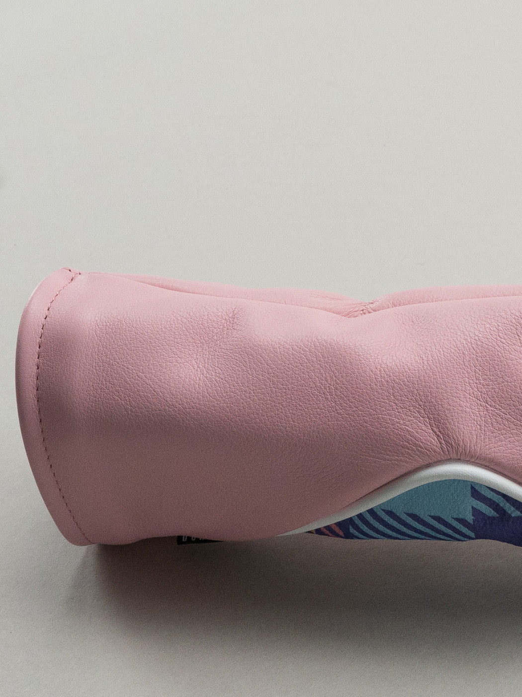 Pink golf club head cover with a pink yellow and blue plaid window
