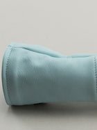 Close up of blue leather base on Golf club headcover made of pink, yellow and blue plaid with a blue leather base.