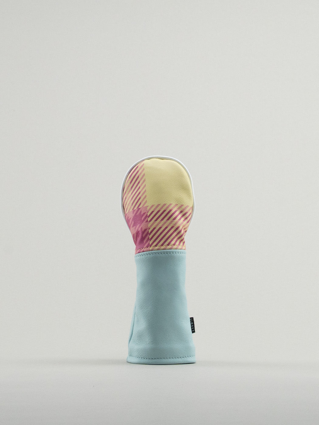 Golf club headcover made of pink and yellow plaid with a blue leather base.