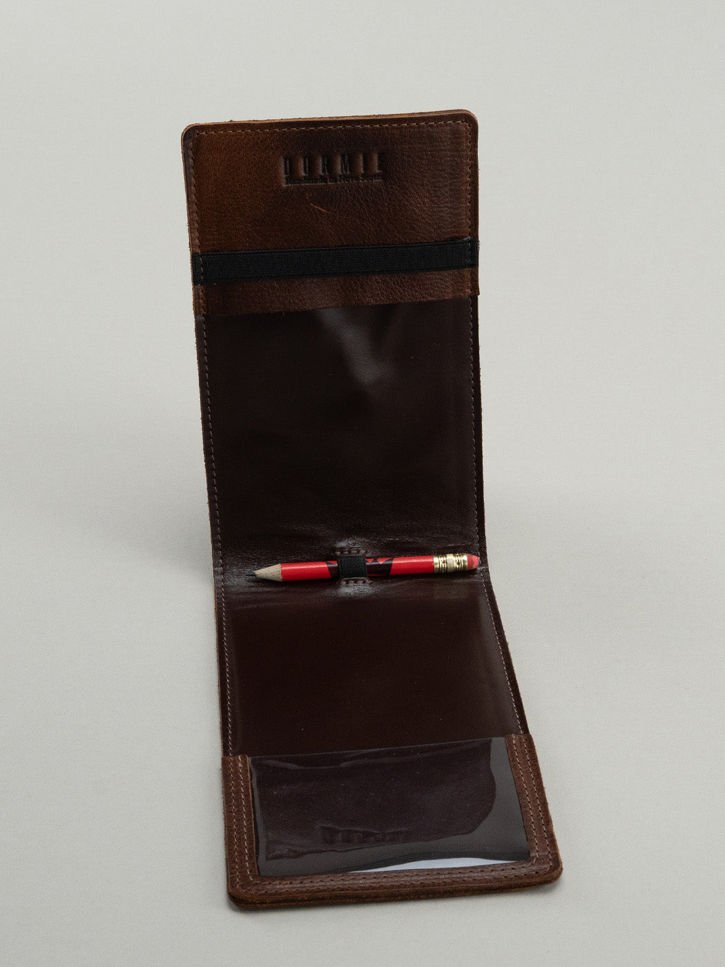 Brown leather yardage book interior with pencil holder