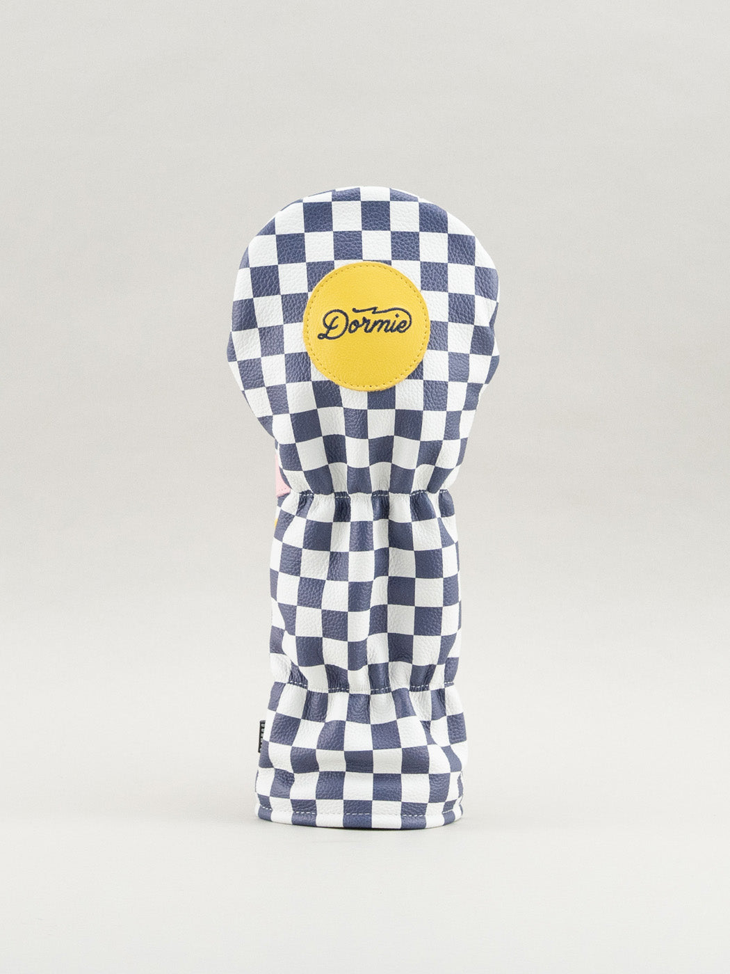 Reverse of checkered golf club headcover showing yellow Dormie badge