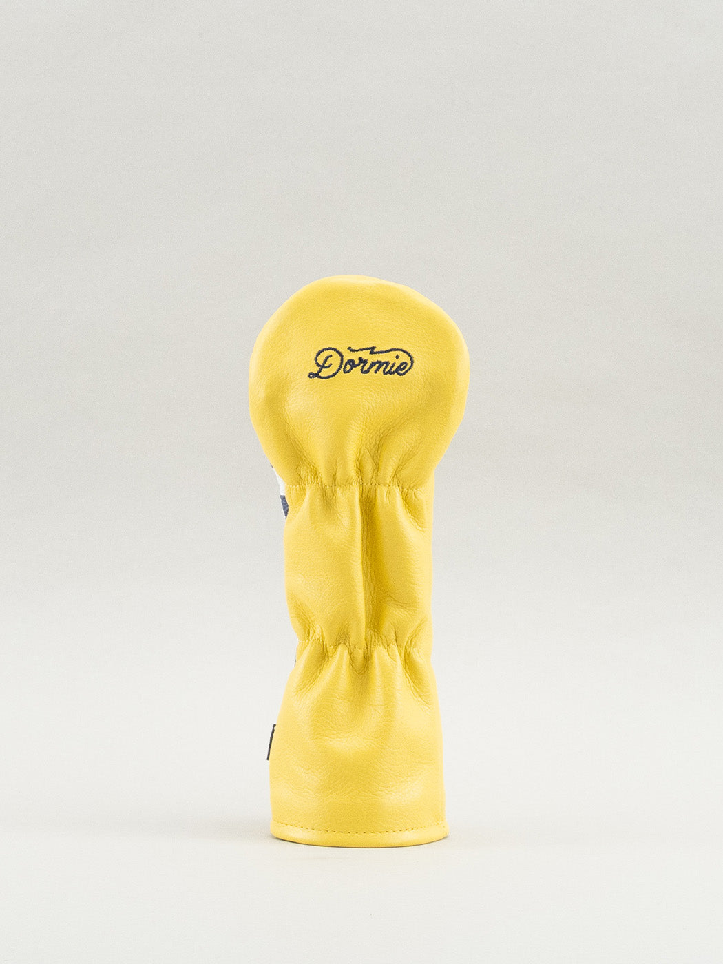 Yellow golf club headcover with Dormie workshop logo