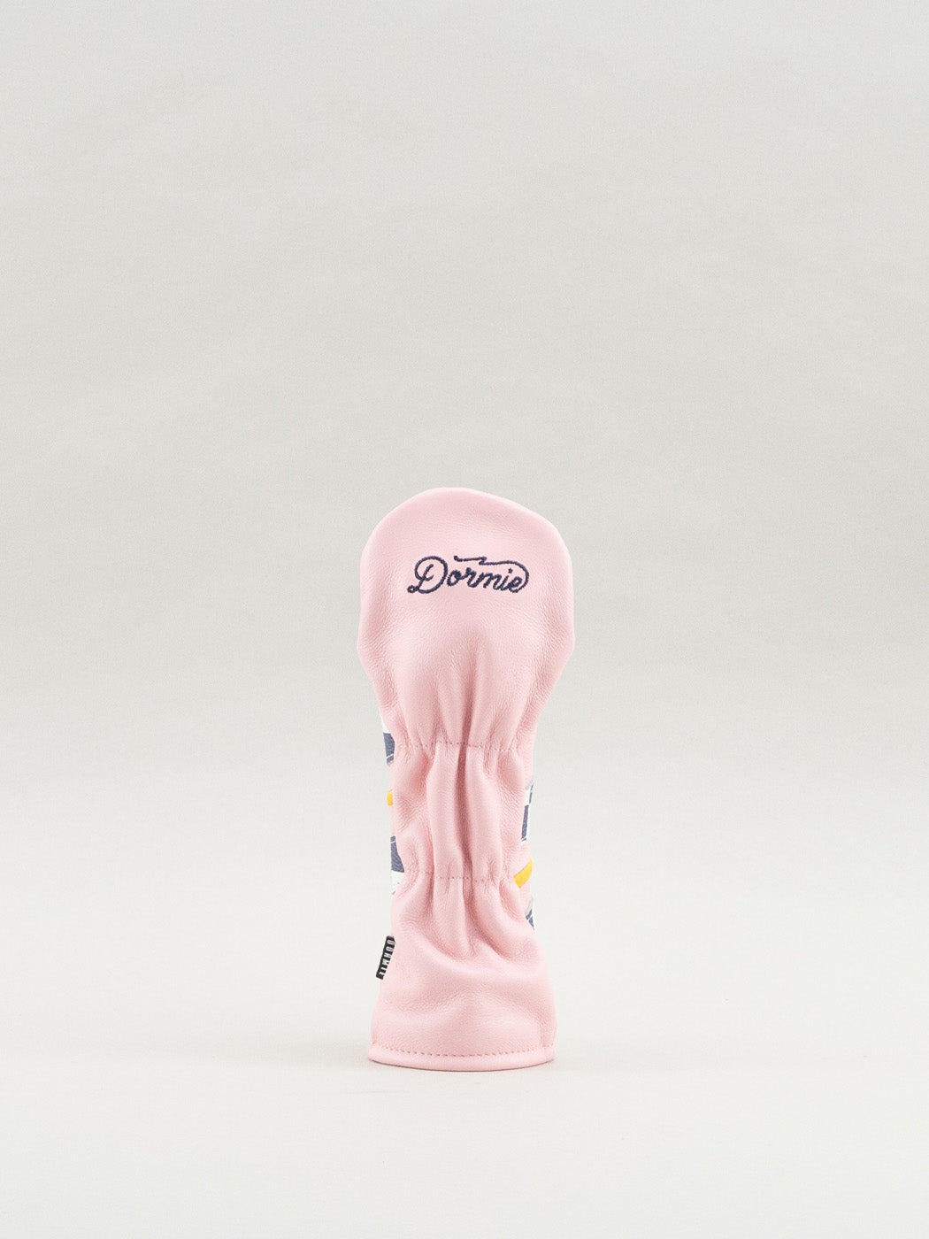 Pink golf club head cover with 'Dormie' branding in cursive font